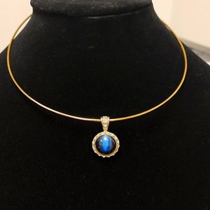 Matching set of necklace and earrings with blue cat's eye in gold tone